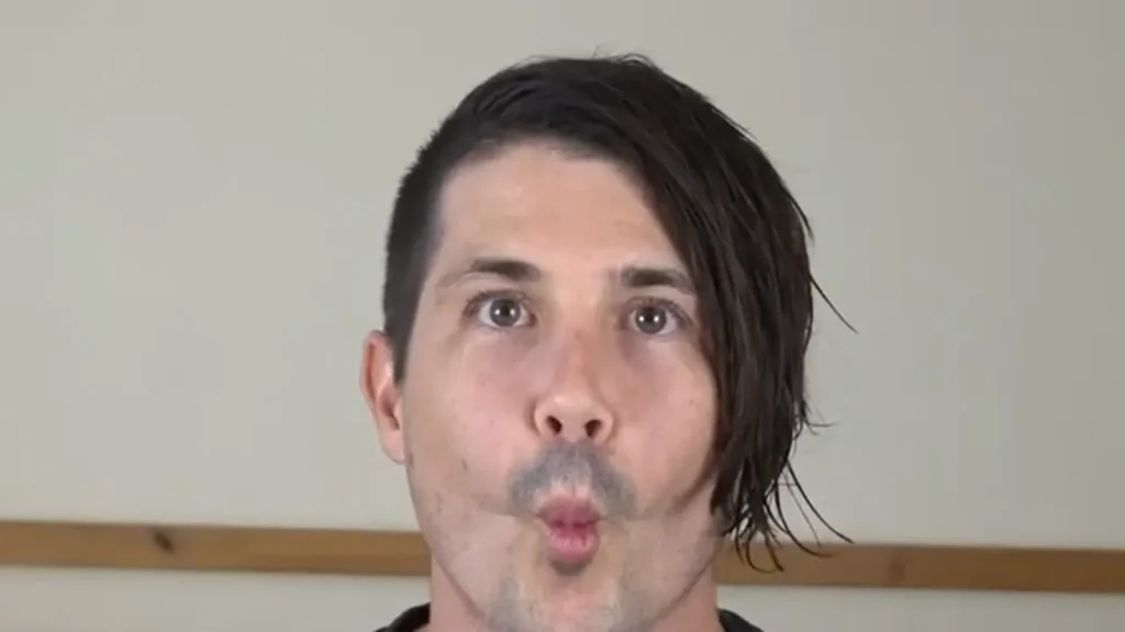 Phoenix Blake hollowing his cheeks to show what suction looks like
